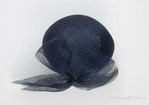 Top view. Luxurious Pinokpok hat with navy straw bow placed on a timeless Beret shape. Hat suitable for Royal Ascot, Epsom races, Weddings, and other special occasion outfits. Handmade Millinery made in London.