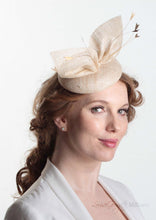 Hayley small disc Hat with bow detail in natural straw. Model side view. Hand