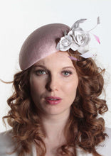 Pink sinamay Beret with white handmade leather flower. Front view of model. Handmade Millinery made in London.
