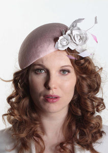 Pink sinamay Beret with white handmade leather flower. Front view of model. Handmade Millinery made in London.