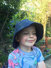 Child wearing oilskin tartan hat made from digital download pattern