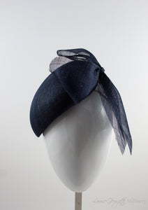 Font view. Luxurious Pinokpok hat with navy straw bow placed on a timeless Beret shape. Hat suitable for Royal Ascot, Epsom races, Weddings, and other special occasion outfits. Handmade Millinery made in London.