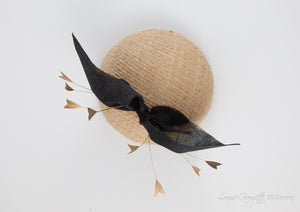 Top view. Cream straw hat with gold feathers and black bow. Suitable for weddings, special occasions and race days. A popular straw style, our signature fun and timeless hat suits most face shapes and can be made in bespoke colours upon request.