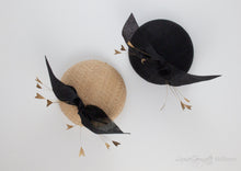 Two straw hat variations of the hayley hat. Hat features a bow on pillbox hat with feather spray.