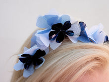 Pale blue, Navy and white flower crown on headband. Close up. Handmade millinery made in London.