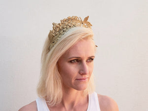 Blonde model wearing gold Lacey headband. Handmade Millinery made in London.