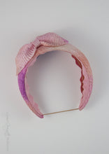 Top view of hand dyed belle headband with bow. 