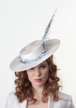 Model wearing Amherst feather Pale blue and white Boater Hat. Handmade Millinery made in London.  Front view.