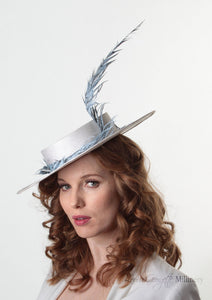 Model wearing Amherst feather Pale blue and white Boater Hat. Handmade Millinery made in London.  Side view.