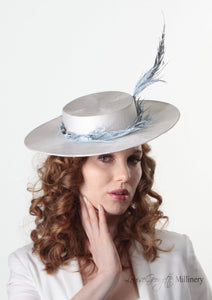Model wearing Amherst feather Pale blue and white Boater Hat. Handmade Millinery made in London.  Front view.