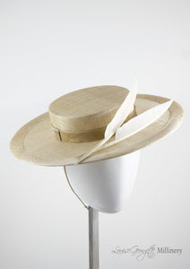 Natural coloured straw boater hat with two cream feathers. Handmade London Millinery. Side view.