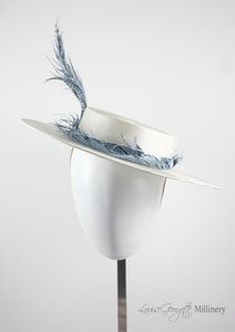 White ladies boater, front view with pale blue feather. Handmade millinery made in London.