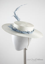 White ladies boater, side view with pale blue feather. Handmade millinery made in London.