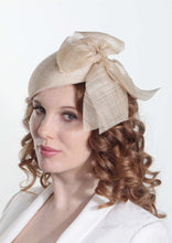 Cassandra natural straw Beret with side bow. Model side view. Handmade Millinery made in London.