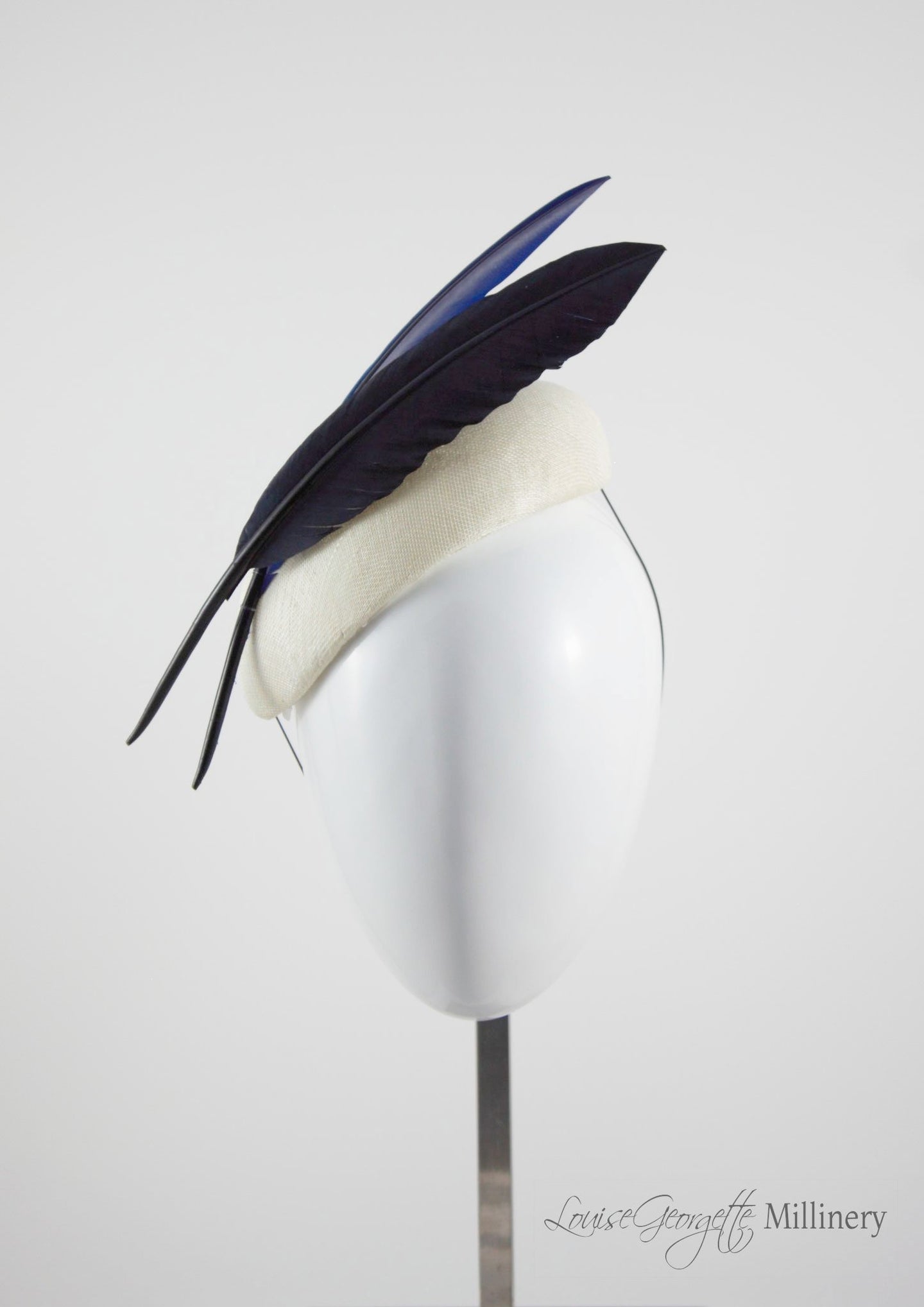 Ivory beret style ladies hat with two quills. Front view. Handmade millinery made in London.