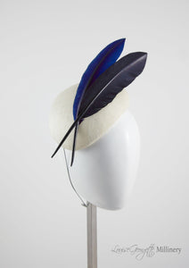 Ivory beret style ladies hat with two quills. Side view. Handmade millinery made in London.