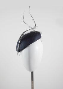 Silver feathers on a navy beret. Front facing. Handmade Millinery made in London.