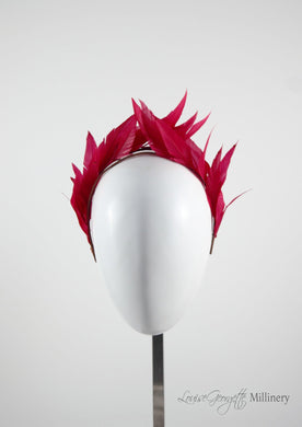 Hand sewn red feathers in crown type shape. Handmade in London and made to order. Front side.