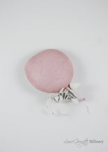 Pink sinamay Beret with white handmade leather flower. Top view of model. Handmade Millinery made in London.