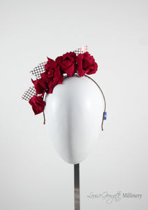 Patterned Leather roses on headband with reflective lattice detail. Millinery handmade in London. Front view.
