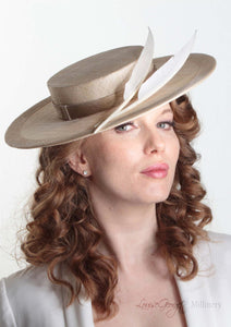 Harper natural and cream boater with two quills. Millinery handmade in London. Side angle view with model.