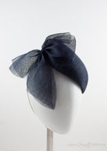 Side view. Luxurious Pinokpok hat with navy straw bow placed on a timeless Beret shape. Hat suitable for Royal Ascot, Epsom races, Weddings, and other special occasion outfits. Handmade Millinery made in London.