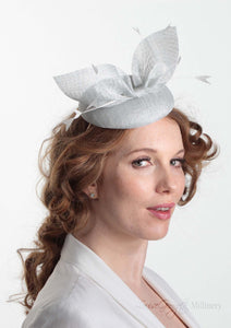 Hayley small disc Hat with bow detail in ice blue. Model side view. Hand