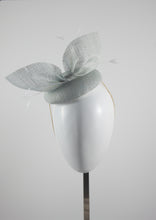Ice blue straw hat with gold feathers. Suitable for weddings, special occasions and race days. A popular straw style, our signature fun and timeless hat suits most face shapes and can be made in bespoke colours upon request.