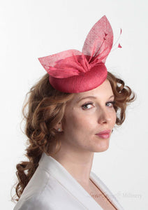 Hayley small disc Hat with bow detail in red straw. Model side view. Hand