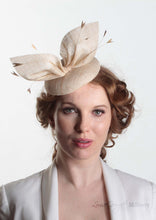 Hayley small disc Hat with bow detail in natural straw. Model front view. Hand