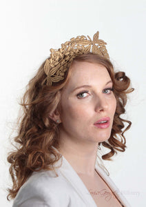 Lacey tiara style gold  crown on headband. Model side view. Millinery handmade in London.
