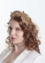 Lacey tiara style gold  crown on headband. Model second side view. Millinery handmade in London.