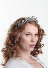 Ivory and Brown/Black stripped feather headband. Model side view. Handmade millinery made in London.