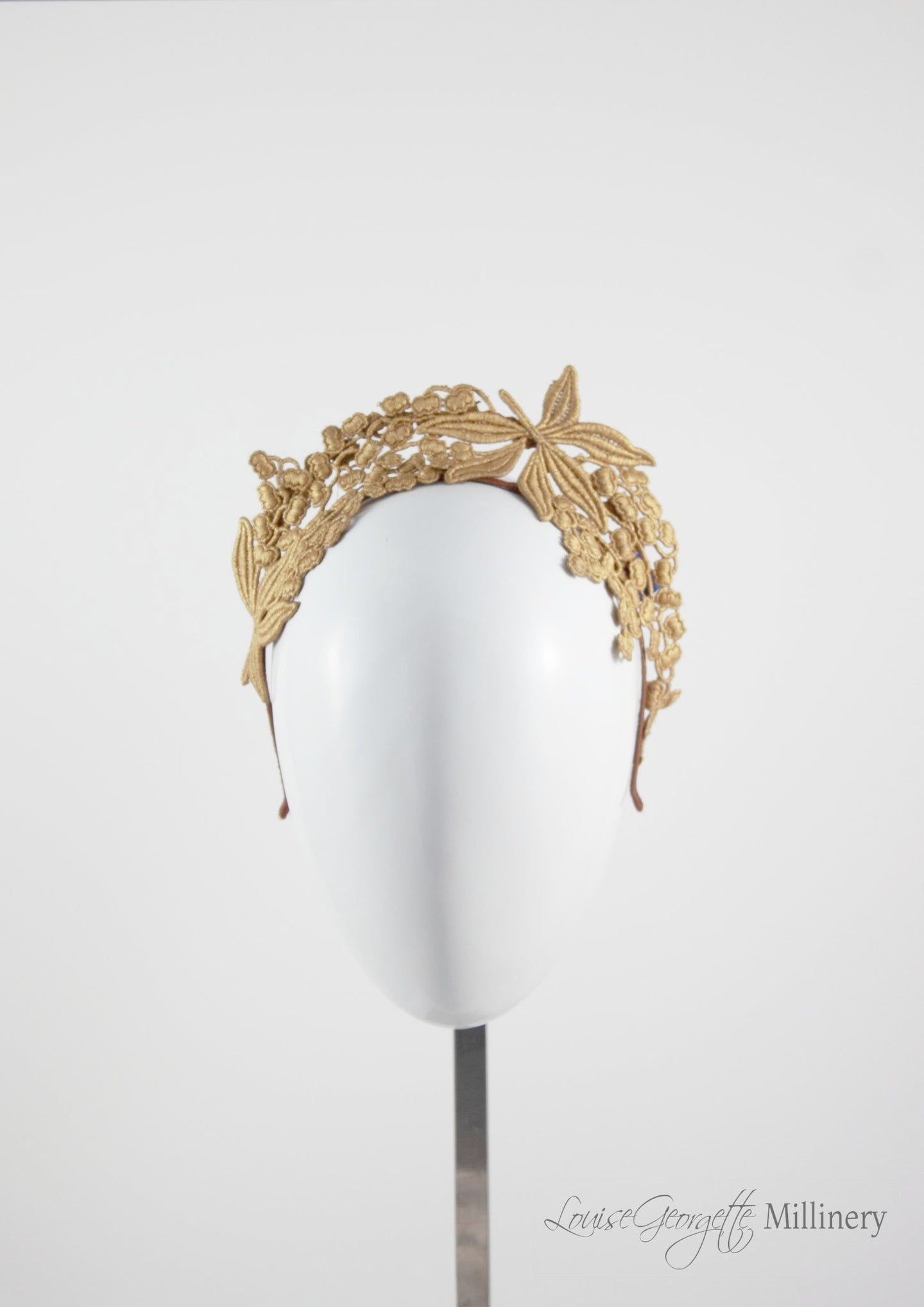 Beautiful tiara style gold lace headband. Suitable for racing events, brides and bridesmaids. Front view. 