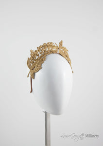 Beautiful tiara style gold lace headband. Suitable for racing events, brides and bridesmaids. Second side view. 