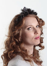 Side facing model in  Sylvie metallic flower crown in black and gunmetal