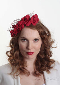 Patterned Leather roses on headband with reflective lattice detail. Millinery handmade in London. Front view on model.