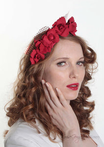 Patterned Leather roses on headband with reflective lattice detail. Millinery handmade in London. Front view with model.